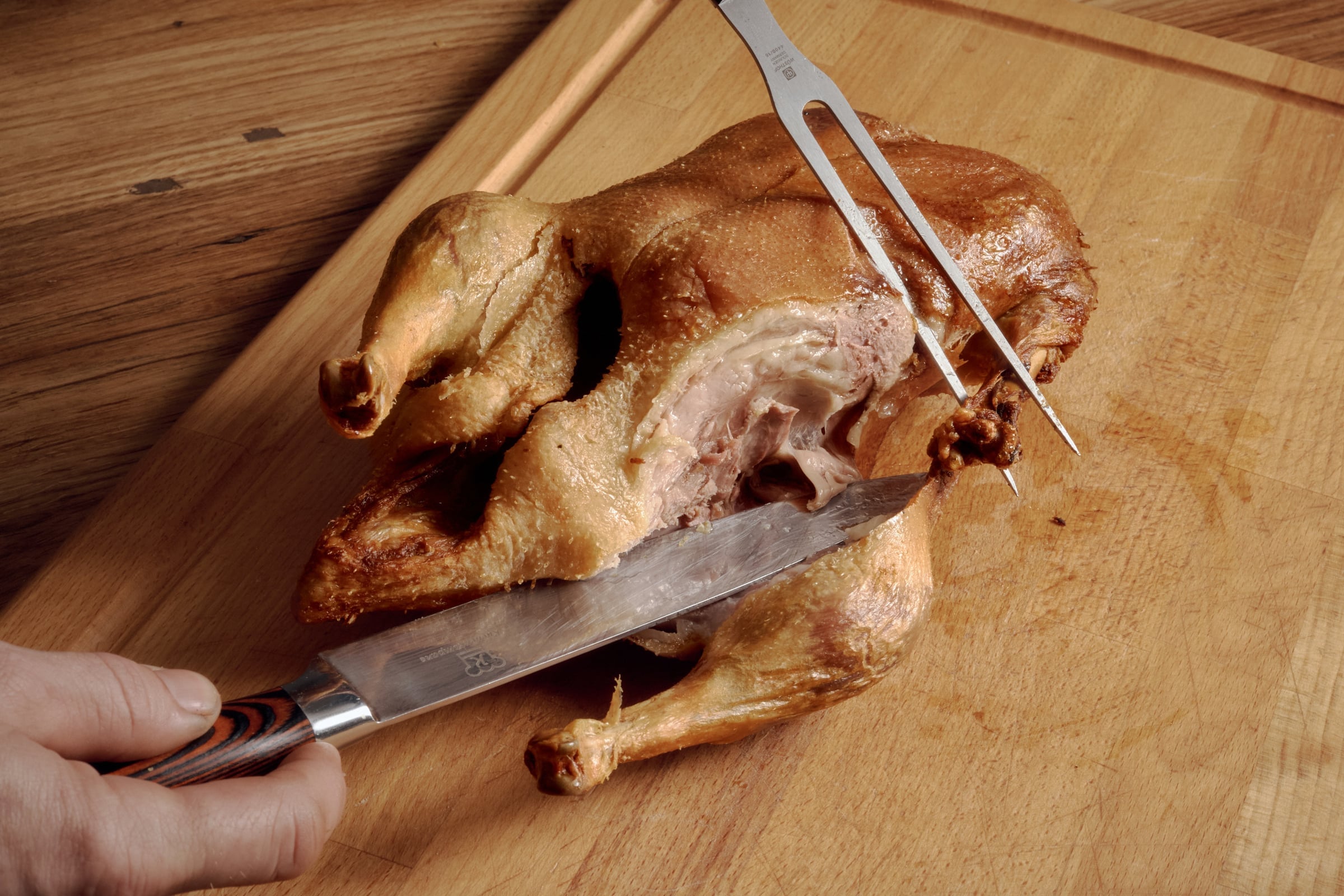 The Vierländer Ente being carved at the table, knife and fork on the crisp skin